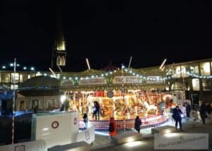 Halifax Piece Hall at Night with fairground carousel and the Spiegeltent used for Piece Hall Christmas events 